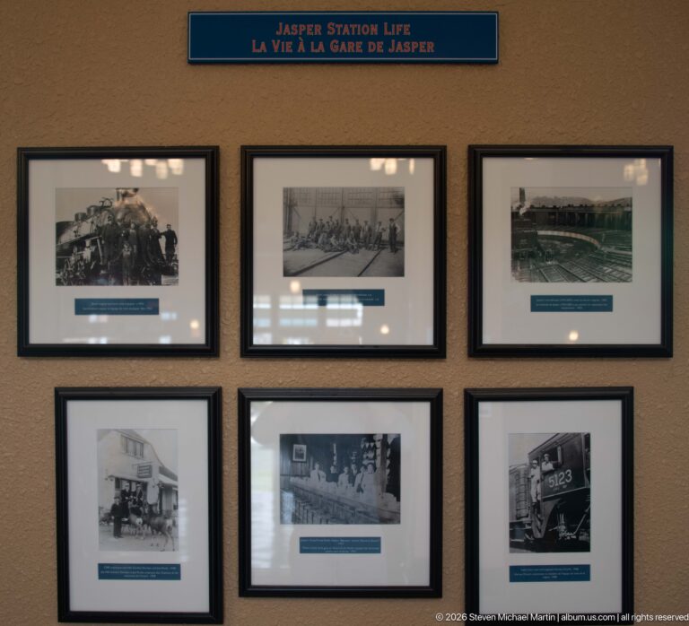 Six framed historic railway photographs beneath the bilingual heading Jasper Station Life on a station wall.