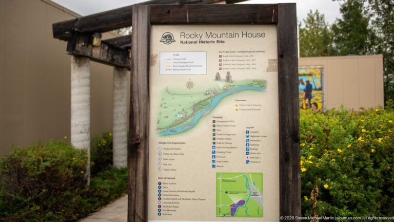 Wood-framed Rocky Mountain House National Historic Site orientation map with river, trails, numbered features, and legend.