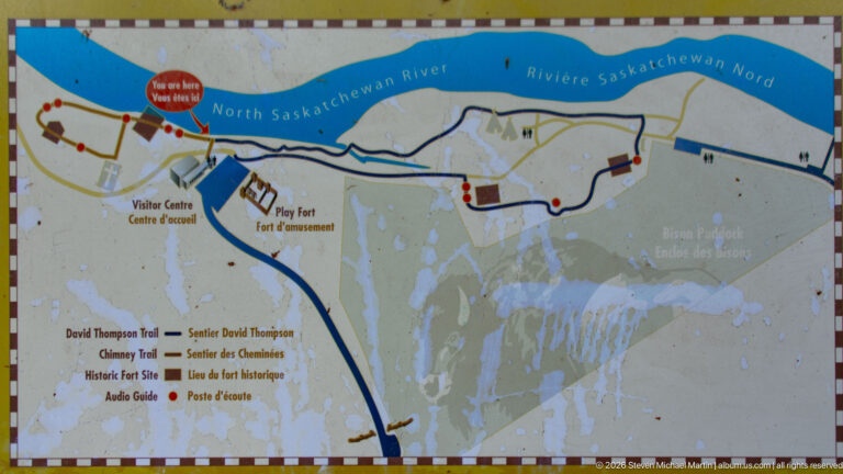 Weathered map showing the North Saskatchewan River, visitor centre, play fort, and several color-coded trails at Rocky Mountain House.