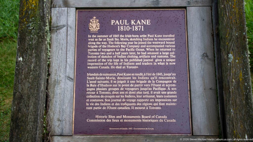 Bilingual Historic Sites and Monuments Board plaque for Paul Kane, 1810–1871, mounted within a heavy timber frame.