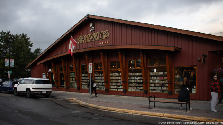 Stonewaters Home occupies a dark red timber storefront with broad display windows and a projecting Canadian flag.