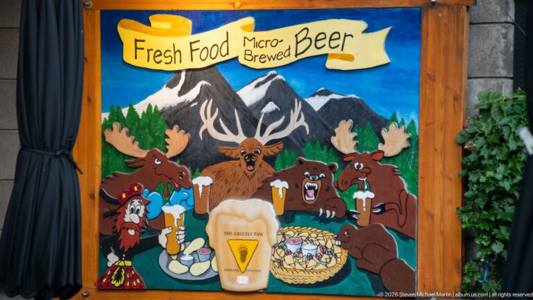A colorful Grizzly Paw mural portrays cartoon bears, mountains, food, and a branded beer glass.