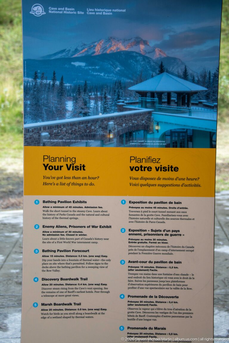 Bilingual “Planning Your Visit” panel with two columns of visitor topics over a winter site photograph.
