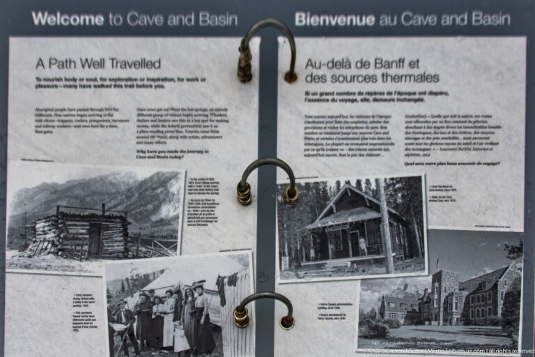 Open ring-bound history display with archival photographs and bilingual text about the Cave and Basin.