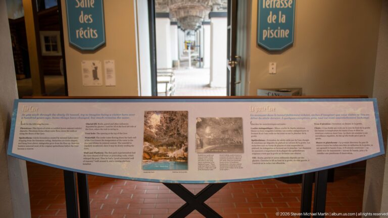 A blue-edged spring-life panel stands beside a doorway marked “Terrasse de la piscine.”