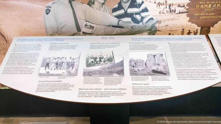 A chronological museum panel pairs archival photographs with a central glass case and bilingual text.