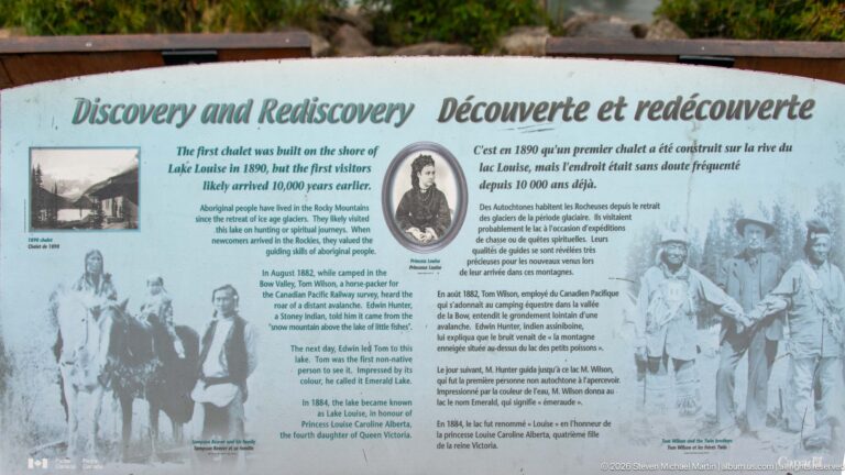 A “Discovery and Rediscovery” sign presents historical text, portraits, and archival images about Lake Louise.