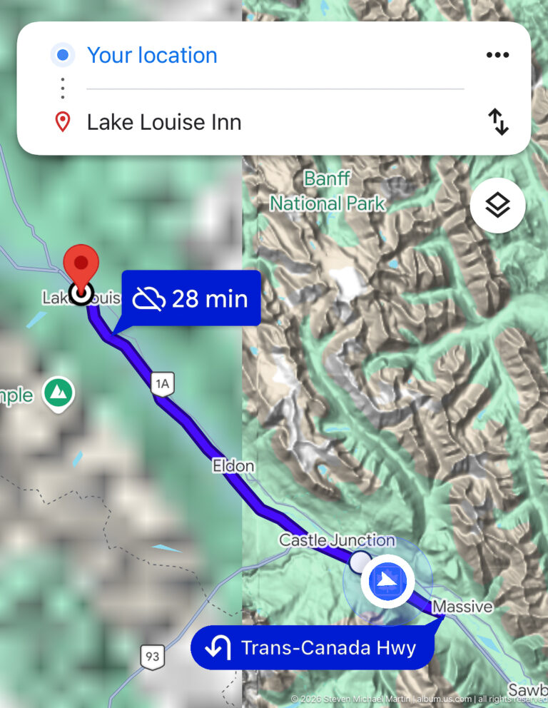 A digital map shows a highway route through Banff National Park toward Lake Louise.