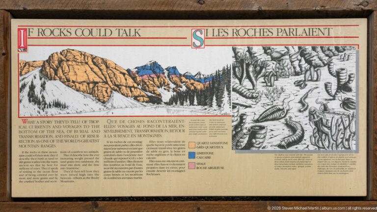 Bilingual Rocks Talk geology panel with mountain illustration, fossil drawings, colored rock units, and explanatory text.