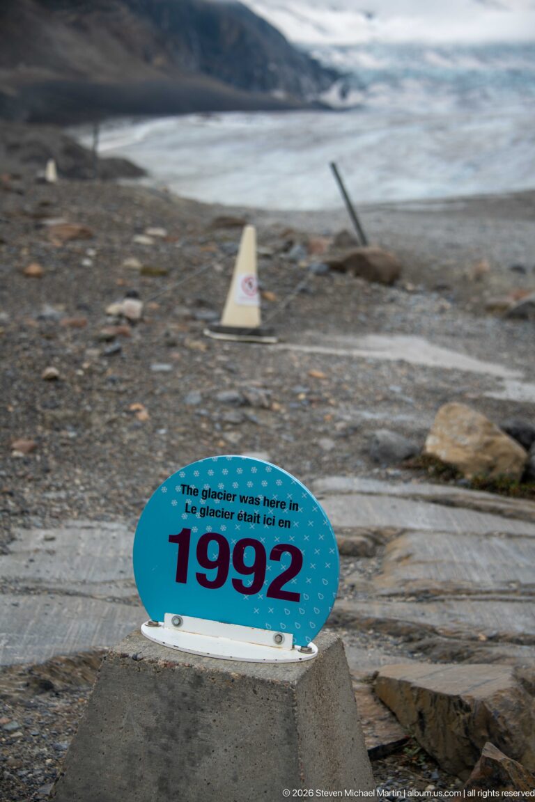 A blue marker states that the glacier was at this location in 1992 the present glacier lies far behind across exposed rock.