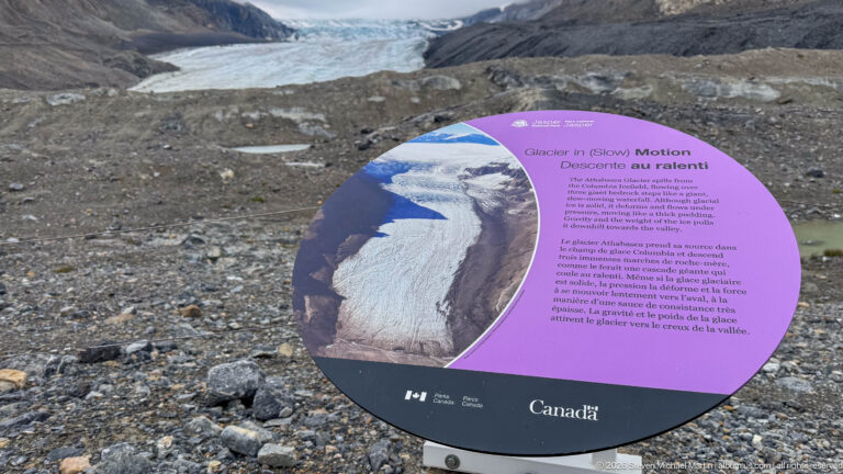 Purple Parks Canada panel titled Glacier in Slow Motion with an aerial glacier photograph and bilingual explanatory text.