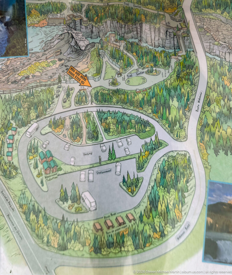 Illustrated bird’s-eye map showing roads, parking loops, trails, buildings, forest, and the Athabasca Falls area.
