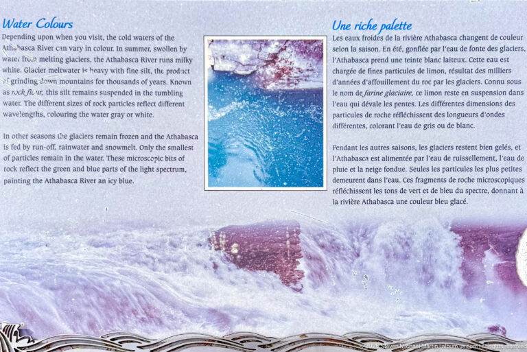 Blue interpretive panel with close-up turquoise water, river scenery, and bilingual text about changing water color.