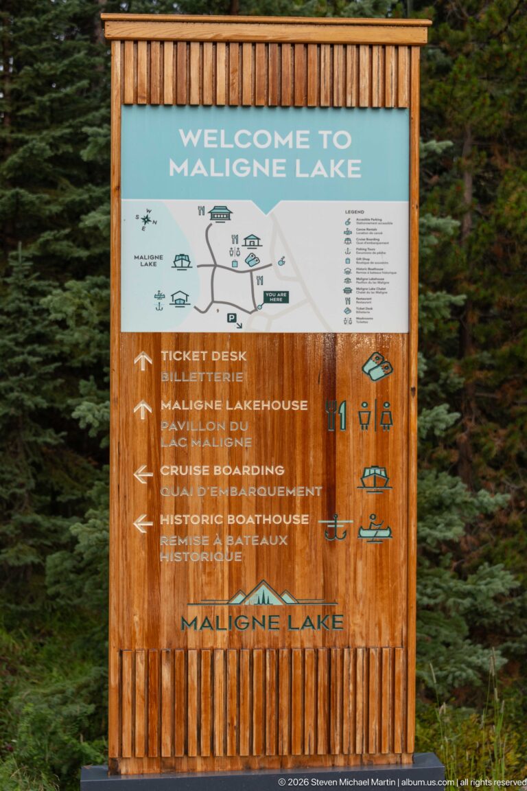 A large wooden Welcome to Maligne Lake board maps visitor services and points toward ticketing, the boathouse, cruise boarding, and other facilities