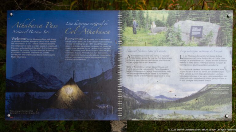 Bilingual Athabasca Pass National Historic Site interpretive panel with historical text and landscape imagery.