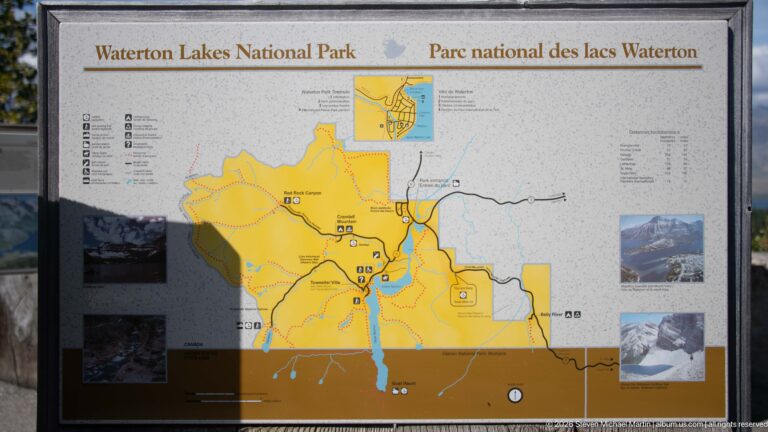 Bilingual Waterton Lakes National Park map panel showing the park in yellow with roads, trails, waterways, symbols, and photo insets.