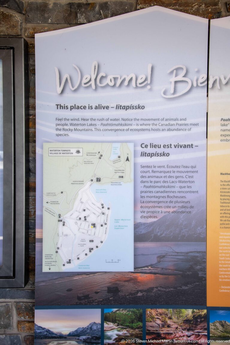 Close view of bilingual welcome panel with “This place is alive,” local map, text, and landscape photographs.