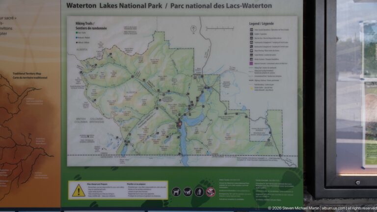 Detailed Waterton Lakes National Park map with roads, lakes, legend, symbols, and safety icons.