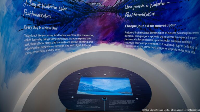 Bilingual “Every Day is a New Day” wall with blue-purple graphics and circular interactive landscape display.